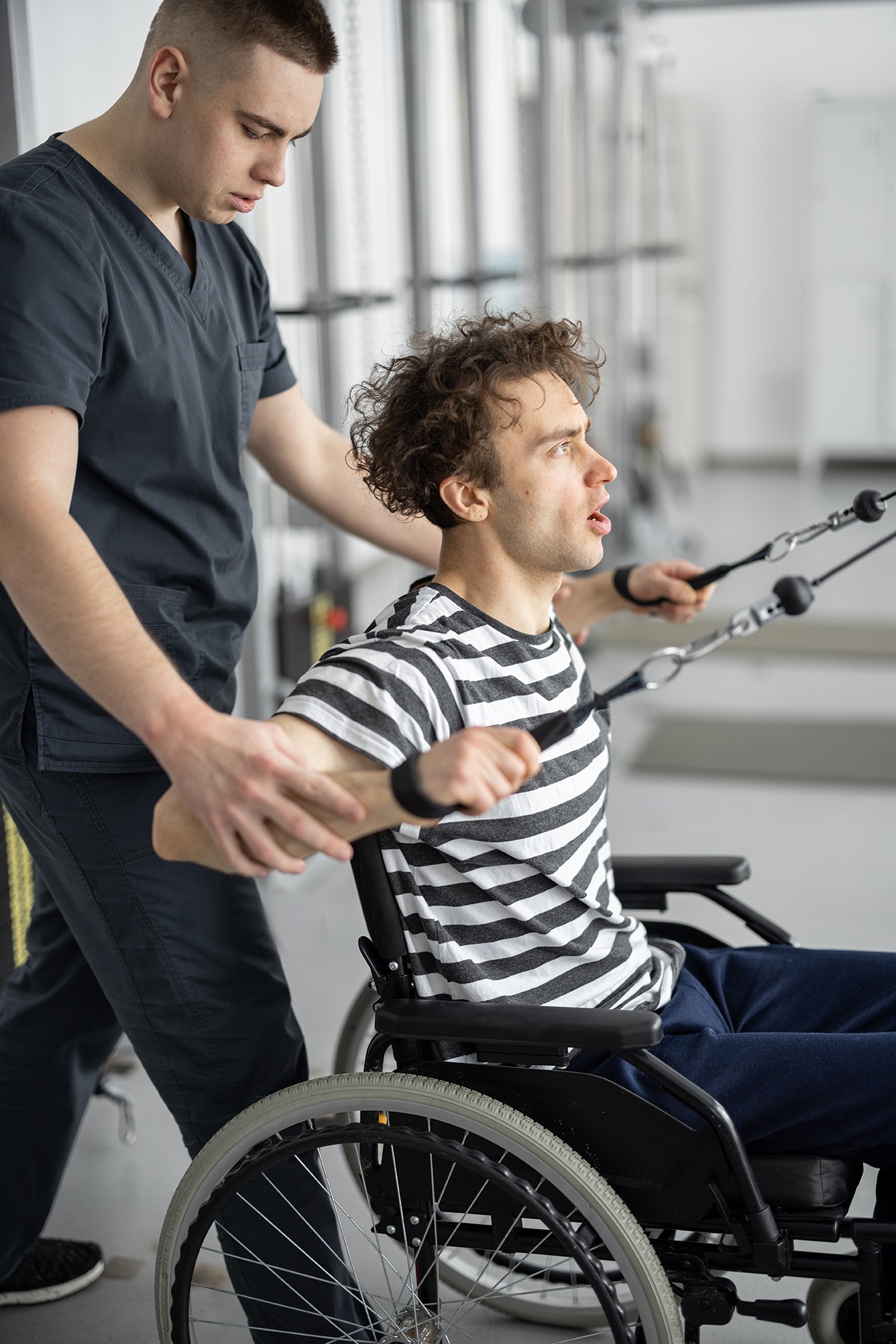 physical therapist assists man in wheelchair with 2026 03 20 02 01 52 utc